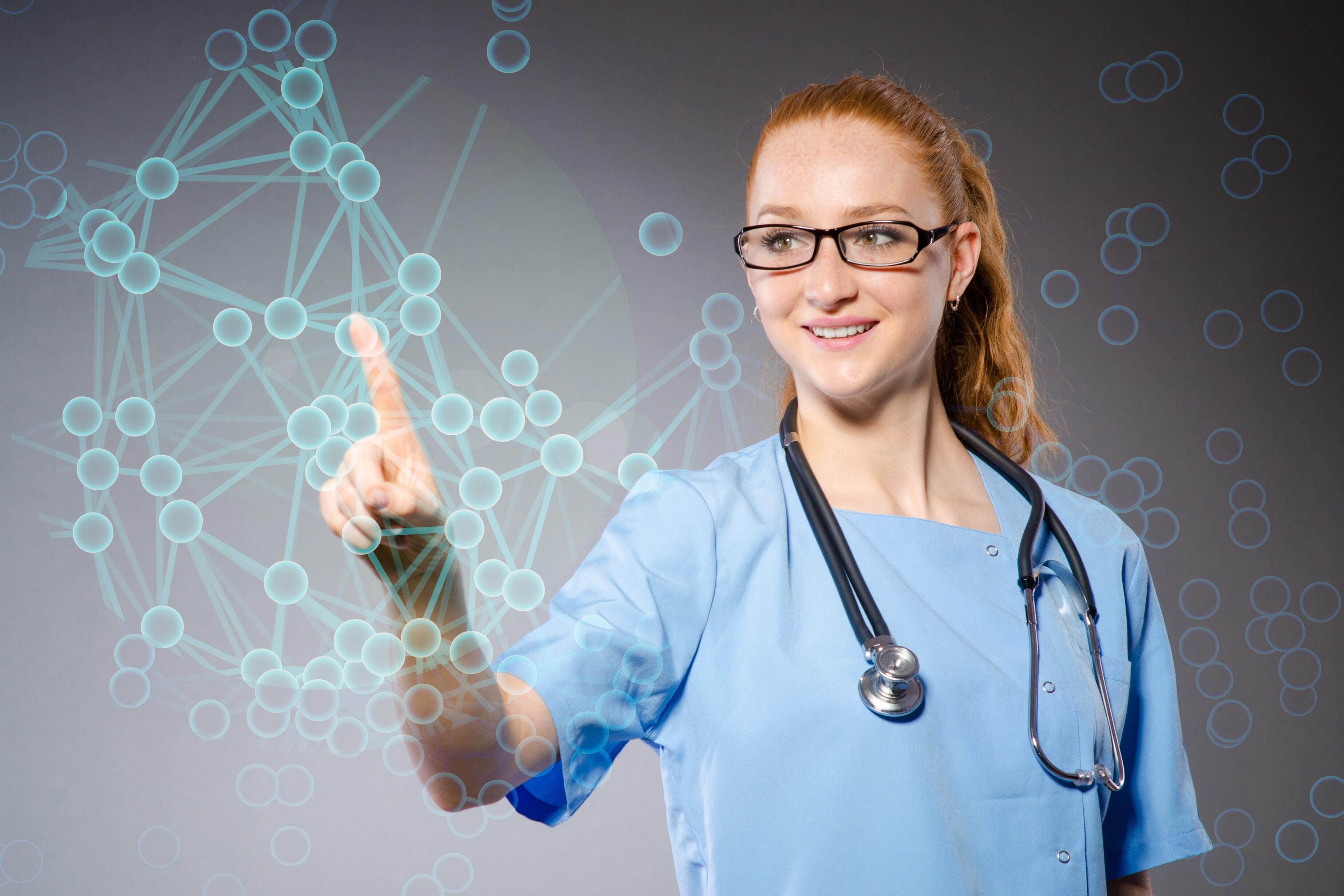 Una donna in camice da medico e con uno stetoscopio punta il dito su un grafico.