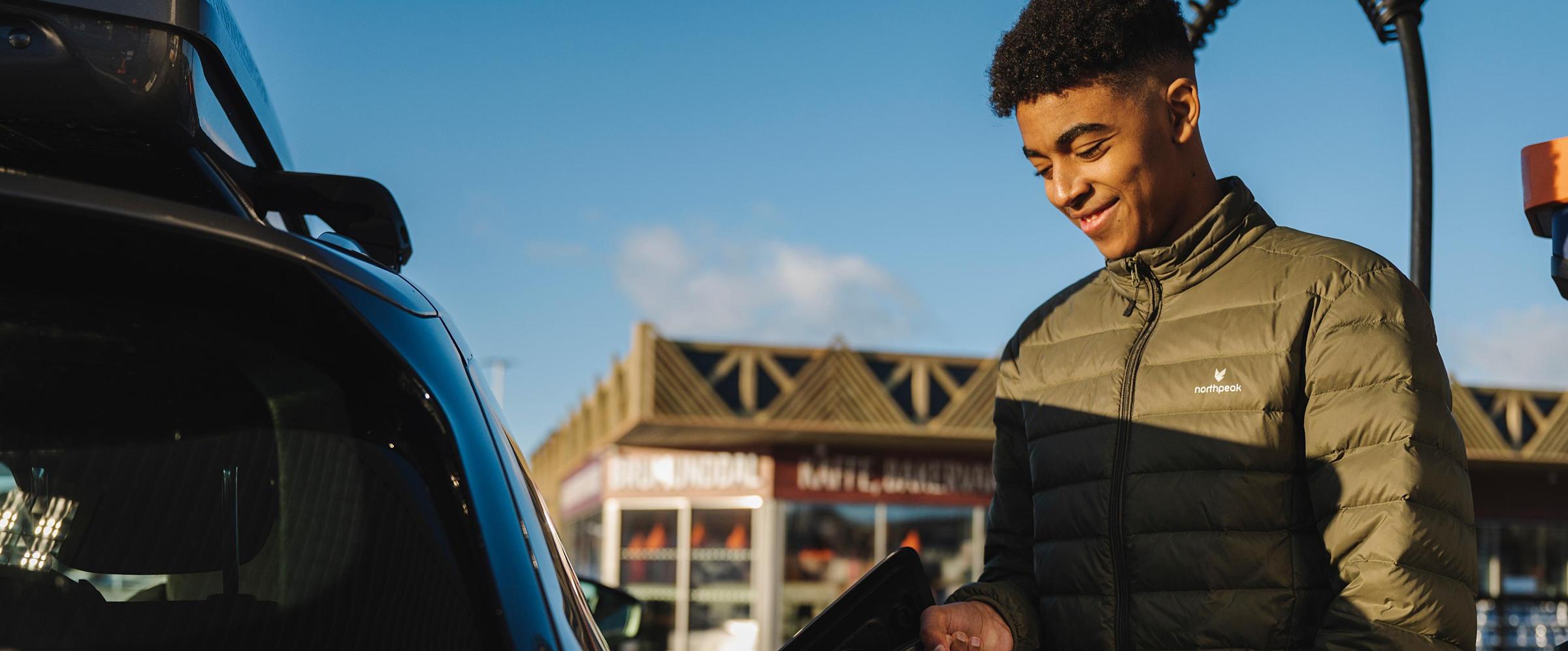 Man som laddar en bil