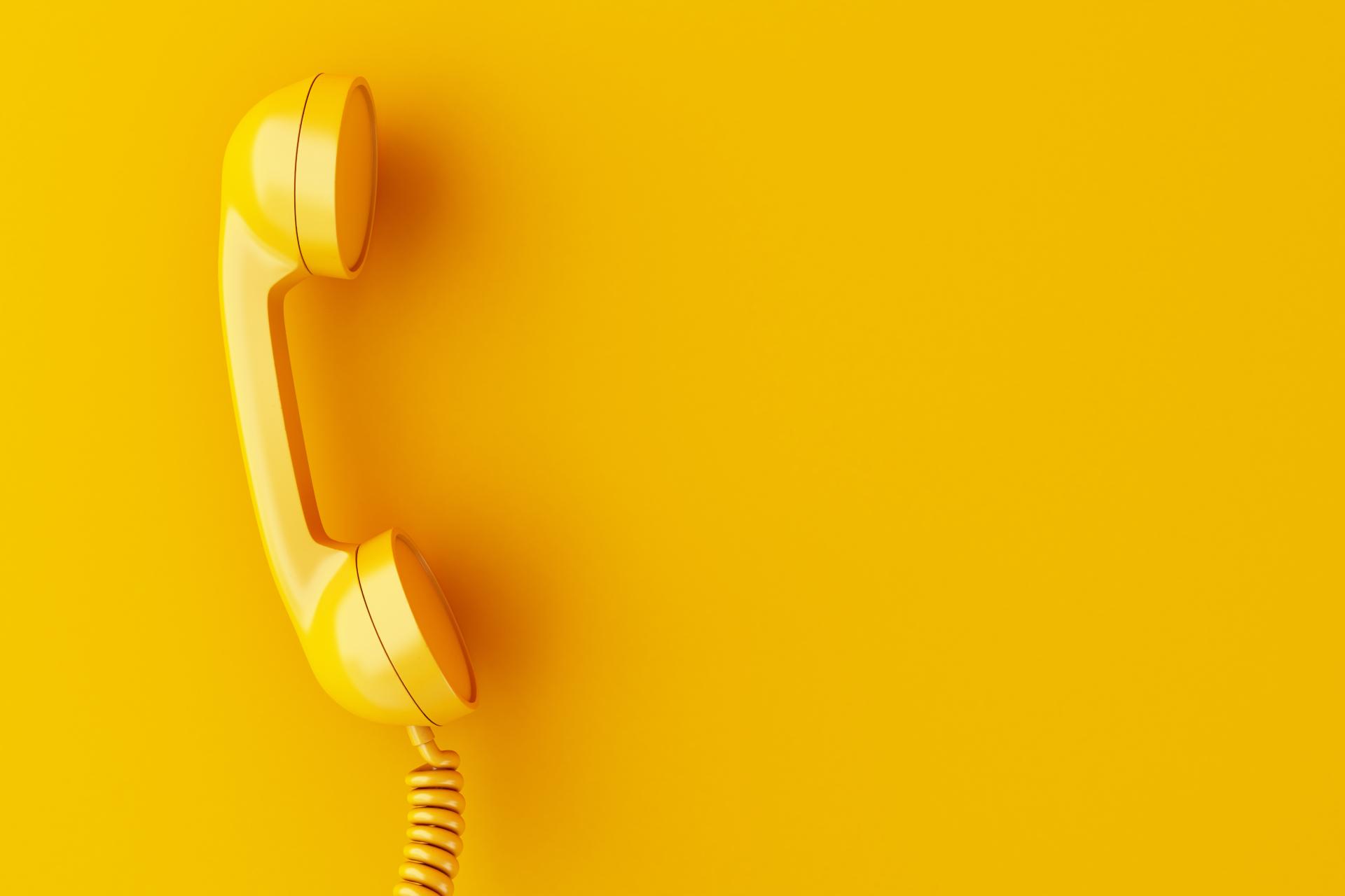 Yellow phone on yellow background