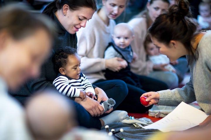 Gruppe mødre og barn deltar på babysang